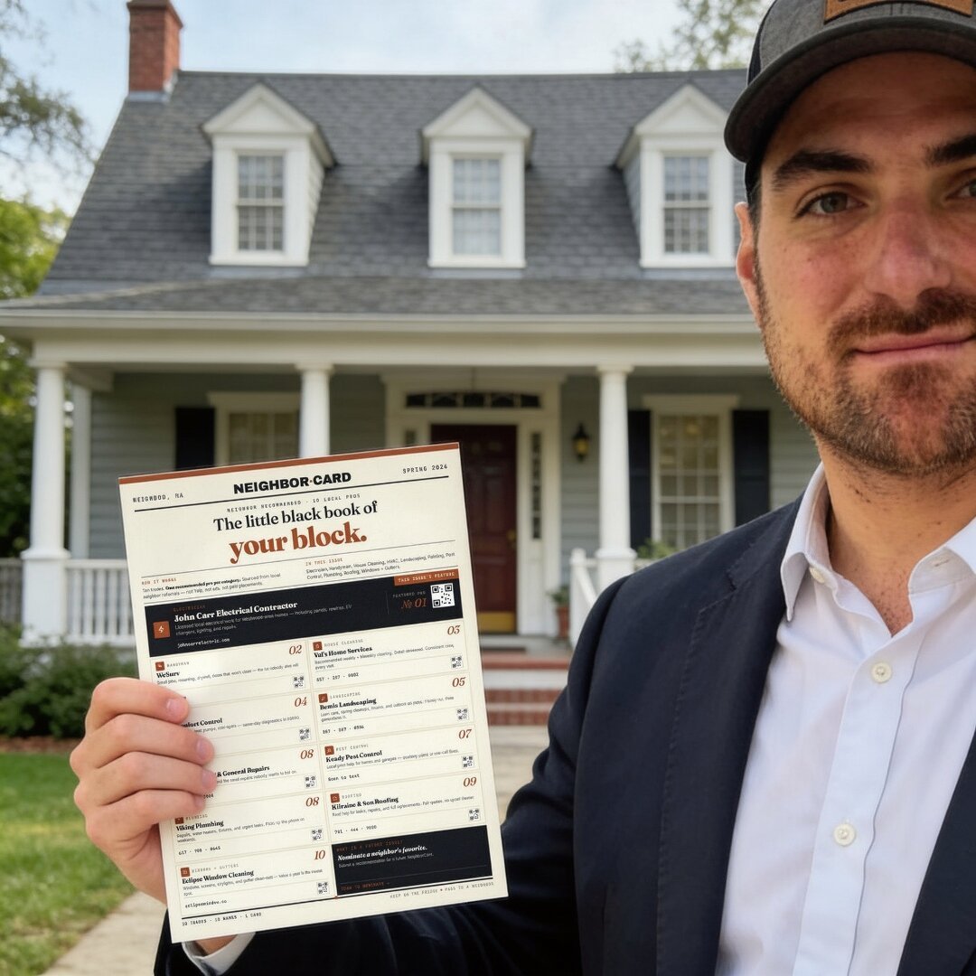Chad holding the NeighborCard in front of a home